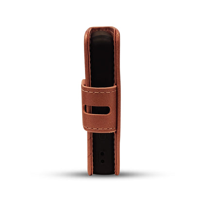 Brown leather case for sleek black electronic device with secure strap