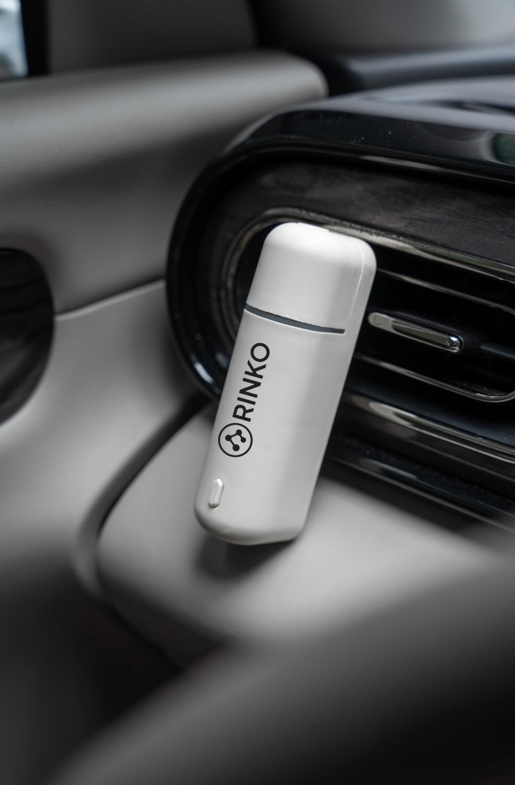 RINKO car air freshener device clipped to dashboard vent for fresh scent